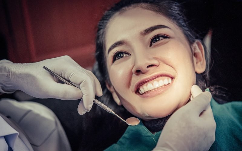 dentist-examines-patient-s-teeth-compressed